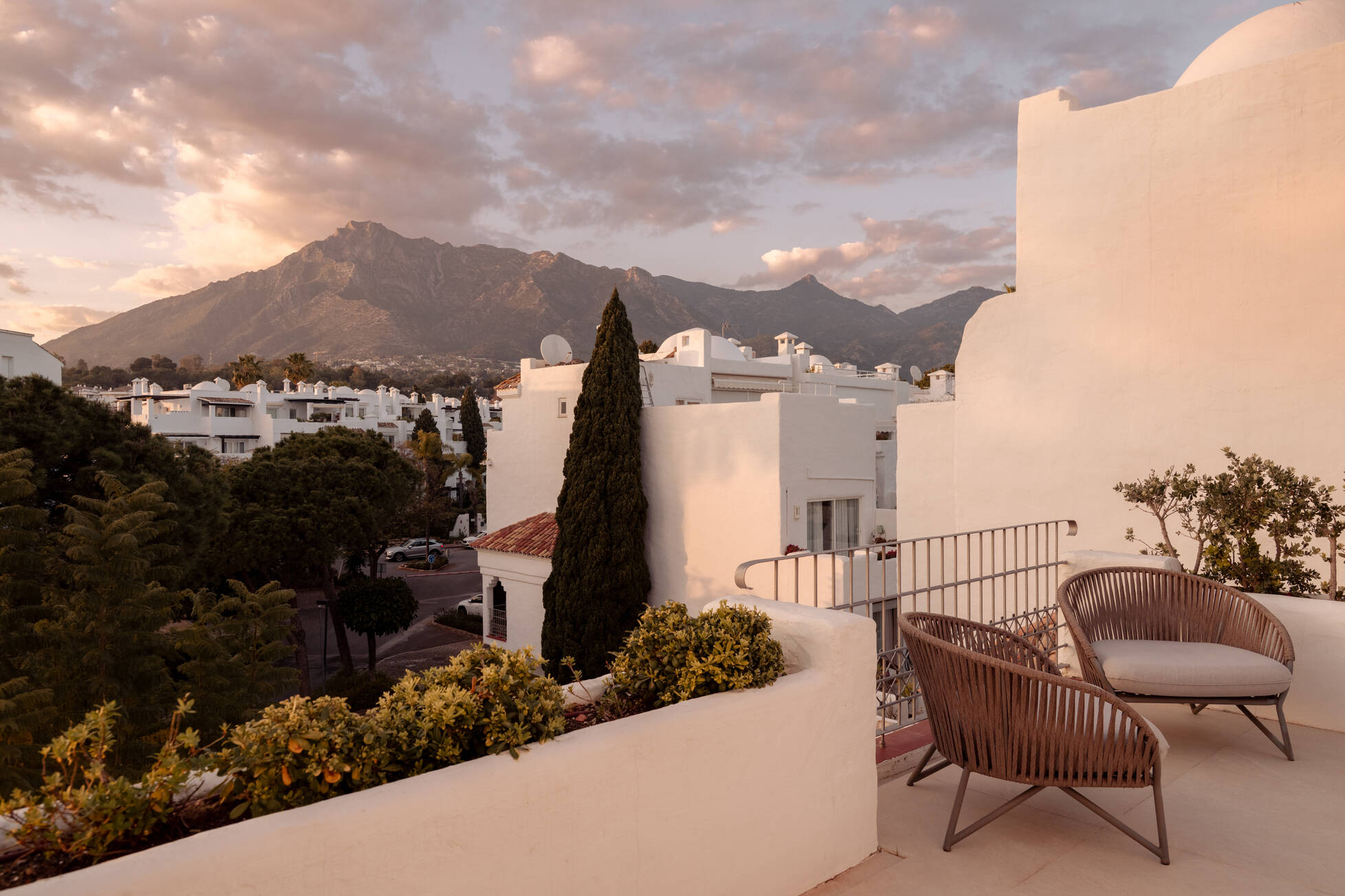 Terrace at sunset with armchairs facing La Concha mountain above the white village rooftops